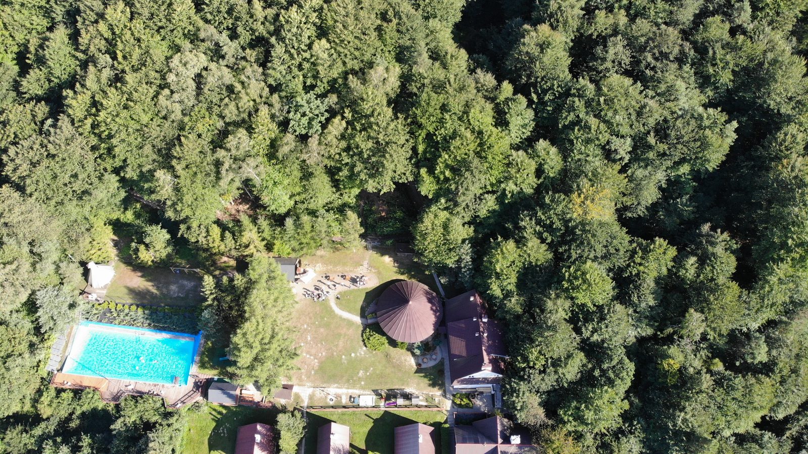 Grupa na placu przy bazie na skraju lasu - widok z drona